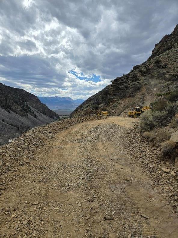 A rocky landscape with a mountain and clouds in the sky AI-generated content may be incorrect.