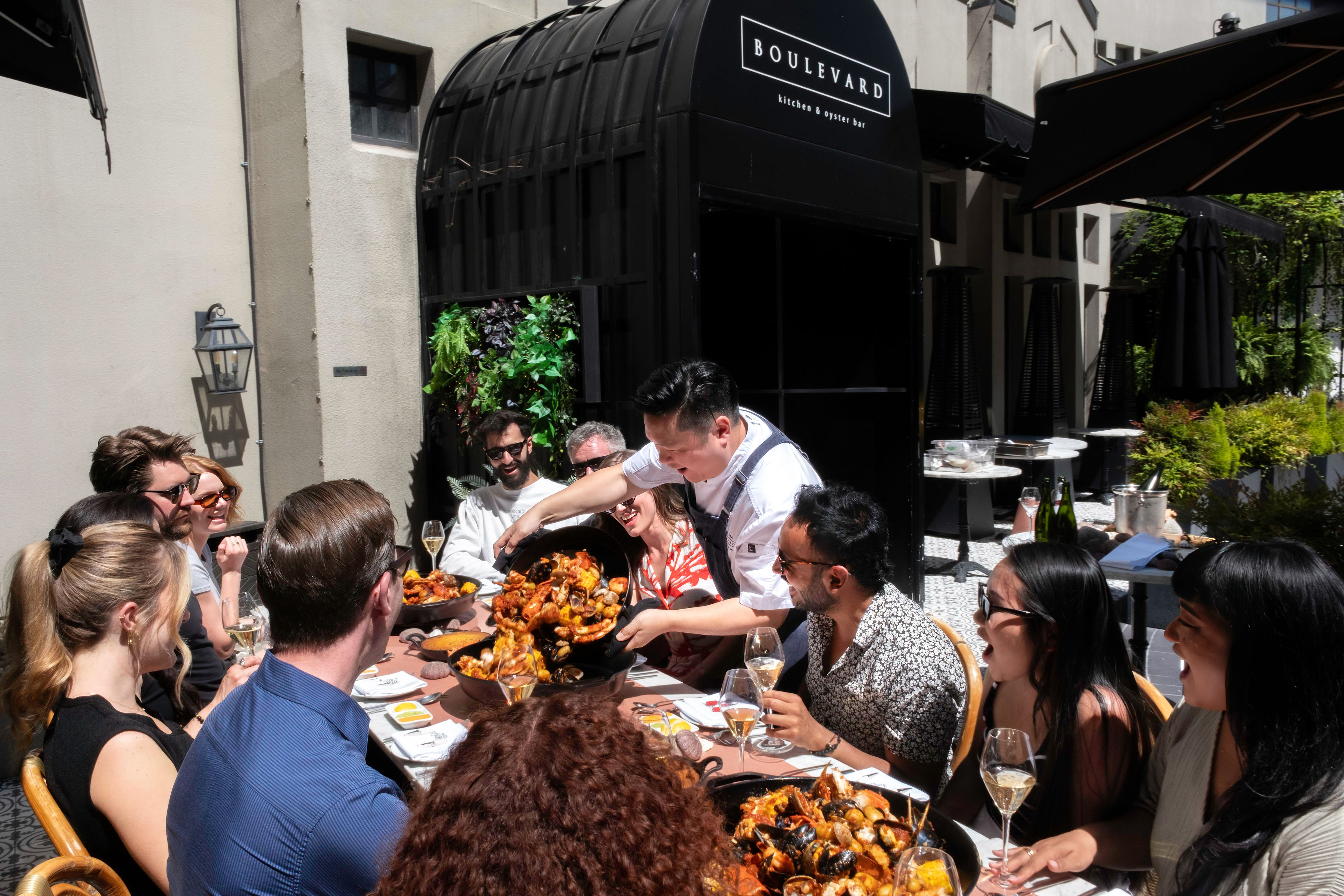 Executive Chef Roger Ma serving at the 2024 Seafood Boil - Boulevard Kitchen & Oyster Bar