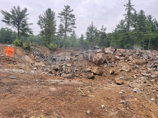 Photo of waste material from the 007 North pit after the blast that is removed prior to drilling and blasting of the targeted gold layer below.