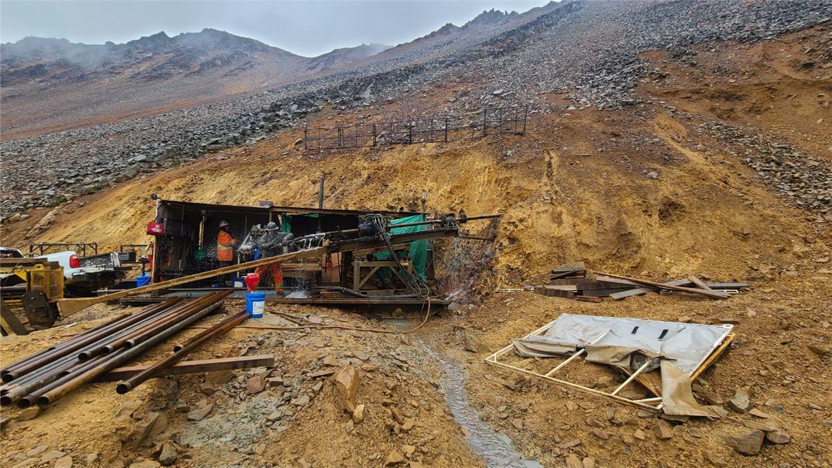 A construction site with a mountain in the background AI-generated content may be incorrect.