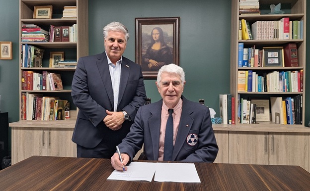 Marco DeVuono, President and CEO, Villa Charities Inc. (L) and Dom Tassielli, Co-Founder, Leonardo Da VinciAcademy of Arts & Sciences (R) co-sign the new affiliate agreement.